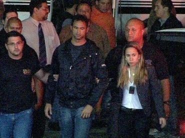 Bruno � levado pelo bra�o pela delegada Alessandra Wilke ao chegar em Minas